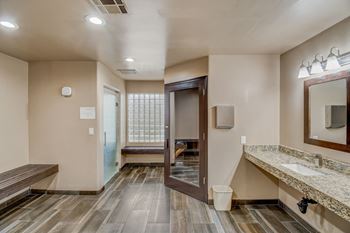 A bathroom with a wooden floor and a marble counter. at San Montego Apartments, Mesa, AZ